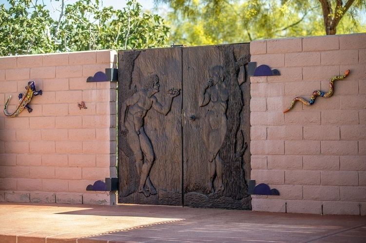 A wooden door with two figures carved into it.