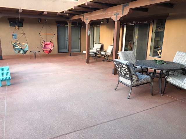 A patio with chairs and tables in it