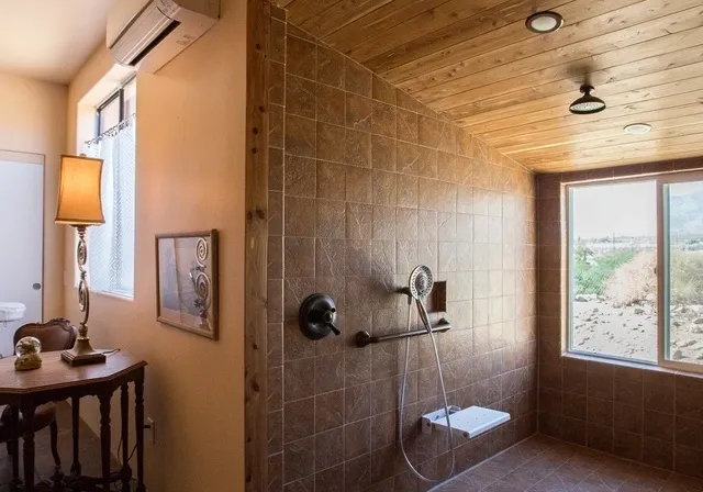 A bathroom with a shower and table in it